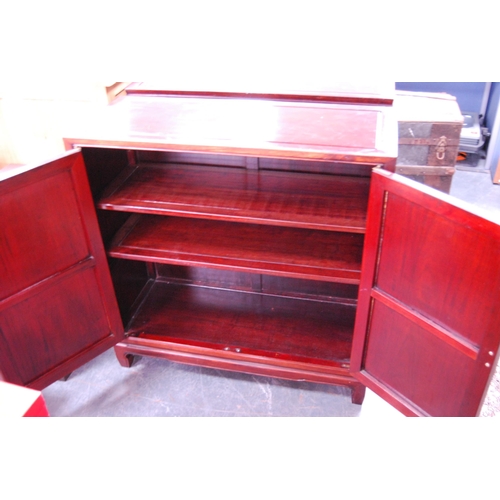 452 - Chinese-style two-door hardwood cupboard enclosing shelves.