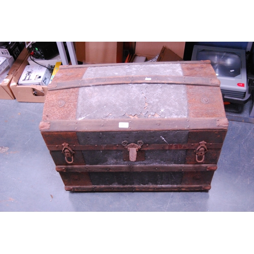 453 - Wood-bound and metal domed travel trunk.