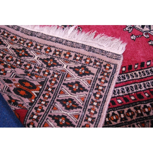 475 - Turkish/Afghan hand-knotted rug on red ground and another Turkish-style rug.  (2)