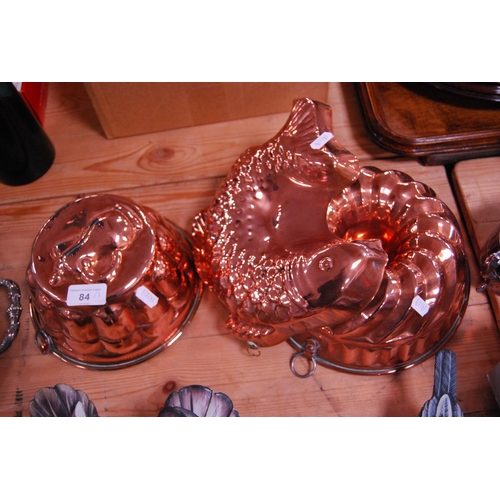 84 - Two copper moulds and another modelled as a fish.  (3)