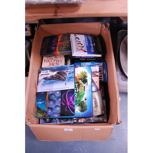 87 - Carton containing miscellaneous books to include Terry Pratchett and assorted DVDs.