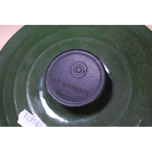 125 - Le Creuset green glazed saucepan and cover and another saucepan lid.