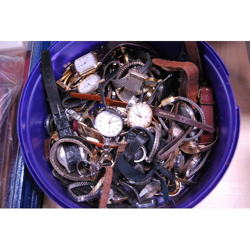 135 - Tub containing manual wind and automatic watch parts and accessories.