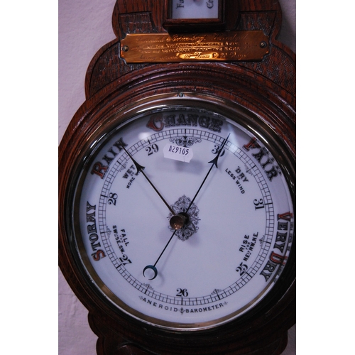 147 - Early 20th century oak banjo aneroid barometer with presentation plaque.