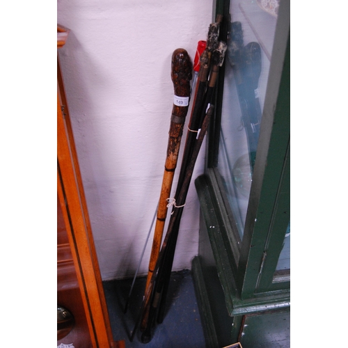 149 - Gun cleaning rods and a fruitwood walking stick.