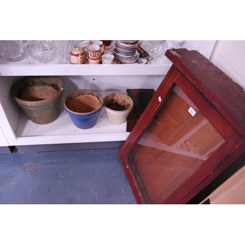 172 - Vintage glazed notice board cabinet, three graduated plant pots and a pair of carved wooden panels (... 