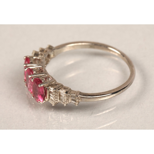 49 - 9ct white gold band set with a trio of pink gems and diamond chip shoulders