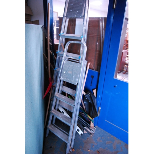 425 - Two sets of aluminium ladders and a quantity of garden tools to include hose, shovel, axe etc.