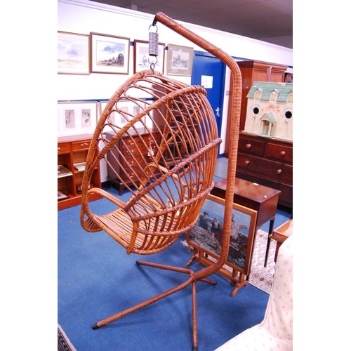 488 - Mid-century bamboo egg chair on suspension stand.