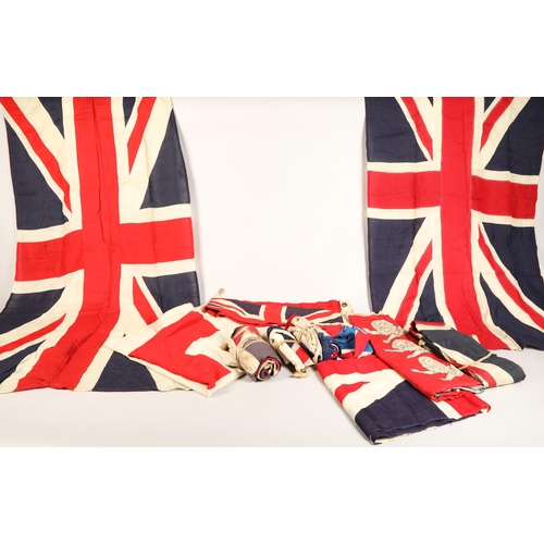 343 - Assortment of vintage flags possibly ship ensigns including eight vintage Union Jack flags, a large ... 