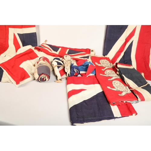 343 - Assortment of vintage flags possibly ship ensigns including eight vintage Union Jack flags, a large ... 