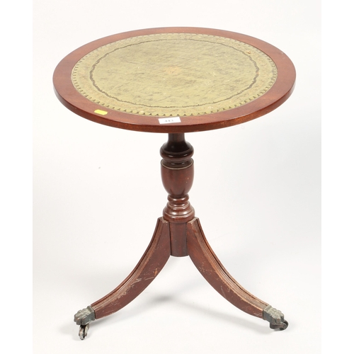 443 - Round leather topped occasional table , 56 cm high 48 cm diameter