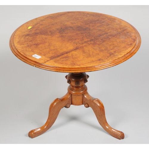 527 - Walnut topped circular tripod table, 61 cm diameter