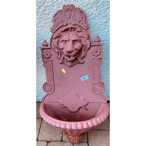 488 - Red iron water feature with lions head, approx 40cm w, 76cm h