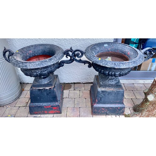 485 - Pair of cast black garden urns, 77 cm high