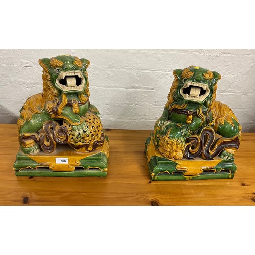 560 - Pair of green and yellow Chinese foo dogs, 36 cm high