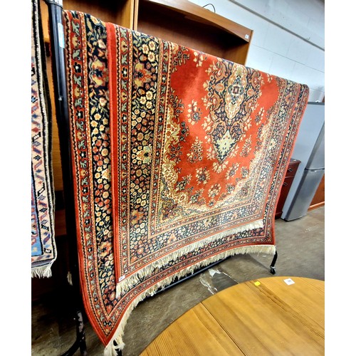 647 - Matching pair, one larger than other, red ground persian style rugs. 197 x 137 cm , 237 x 168 cm