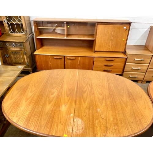 630 - Mid century teak sideboard with glazed bookshelves and drinks cabinet, and extending oval dining tab... 