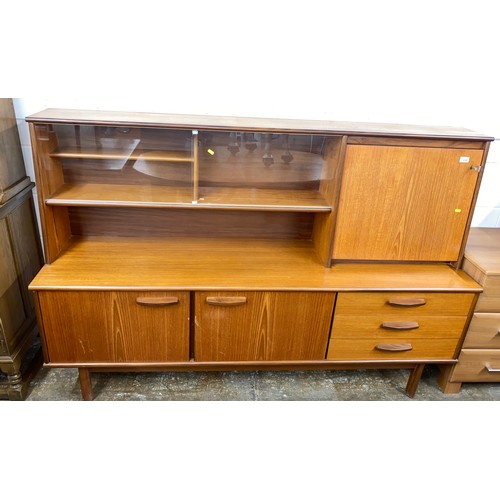 630 - Mid century teak sideboard with glazed bookshelves and drinks cabinet, and extending oval dining tab... 