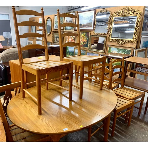 642 - Ercol pine extending dining table with eight chairs