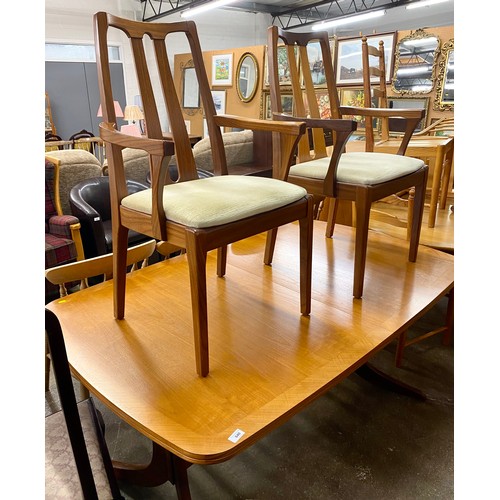 640 - Mid century teak extending dining table with two Nathan arm chairs