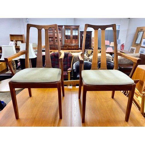 640 - Mid century teak extending dining table with two Nathan arm chairs