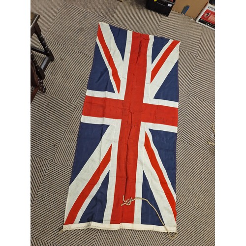 343 - Assortment of vintage flags possibly ship ensigns including eight vintage Union Jack flags, a large ... 