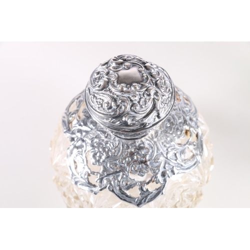 687 - Two silver mounted glass globular scent bottles, 11cm high.