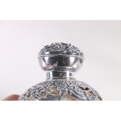 687 - Two silver mounted glass globular scent bottles, 11cm high.