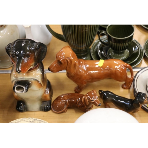 116 - Beswick dachshund model and two others, a novelty teapot, a cup, etc.  (7)