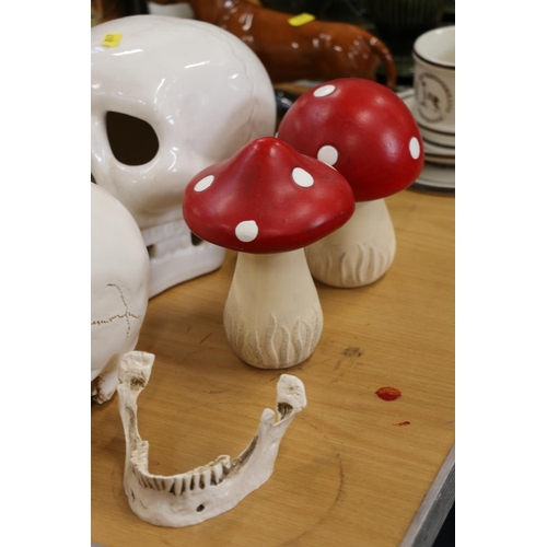 117 - Four decorative skull models and two toadstools.  (6)