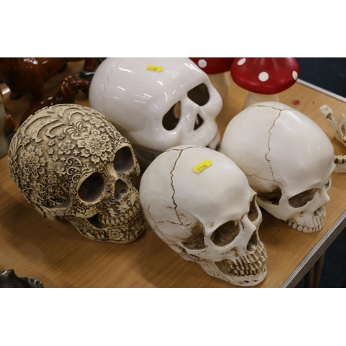 117 - Four decorative skull models and two toadstools.  (6)