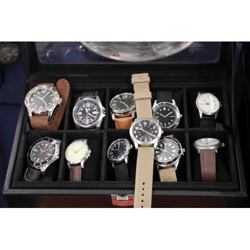 131 - Case containing replica wristwatches, and a watch display case.