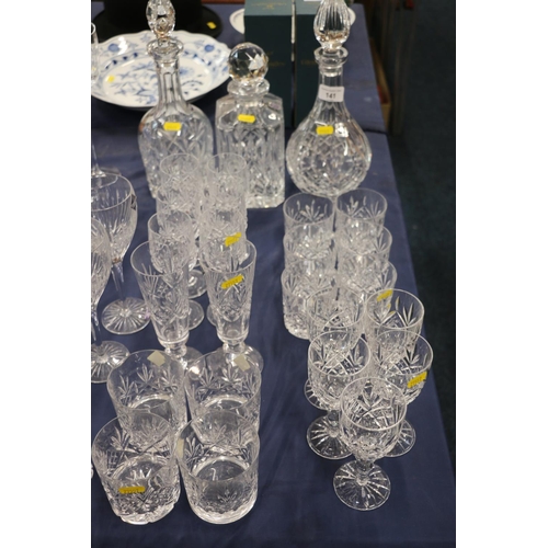 141 - Cut glassware to include an Edinburgh Crystal decanter, glasses, blue glasses, a scent bottle, etc.