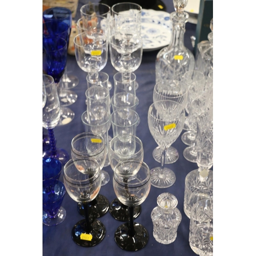 141 - Cut glassware to include an Edinburgh Crystal decanter, glasses, blue glasses, a scent bottle, etc.