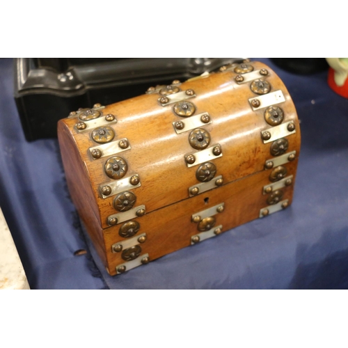 158 - Walnut and dome top hinged casket decorated with mother-of-pearl and metal studs, 19cm wide.