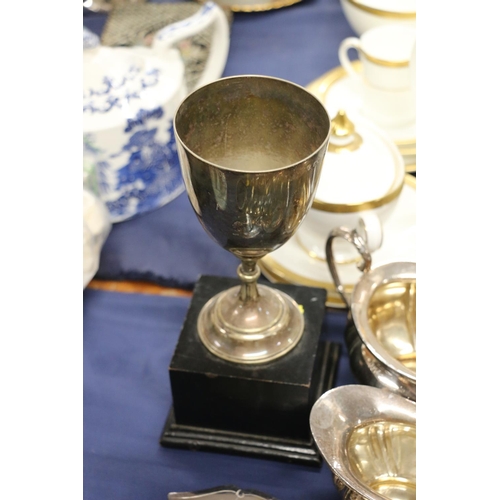 70 - EPNS trophy cup on stand, a part tea service, and EPNS flatware.