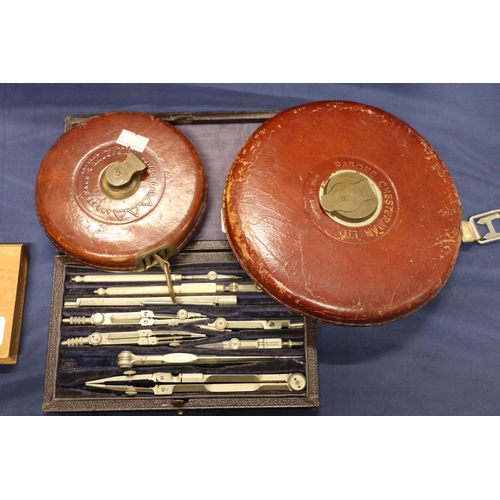 73 - Two Rabone measuring tapes, and a Strand of London  drawing set.