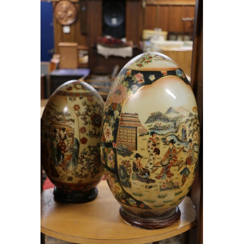 79 - Large oriental style egg shaped ornament, on stand, and another.