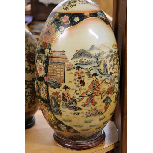 79 - Large oriental style egg shaped ornament, on stand, and another.