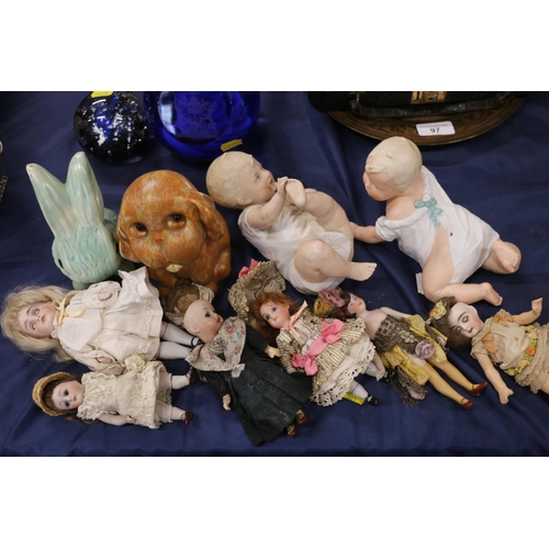 94 - Two bisque porcelain piano dolls, and six small bisque headed dolls.