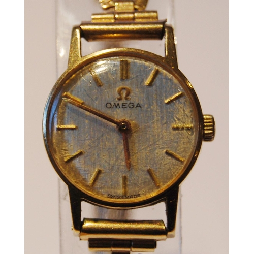 104 - Omega lady's wristwatch with silvered dial, gold baton indices, on pierced rolled gold strap, case d... 