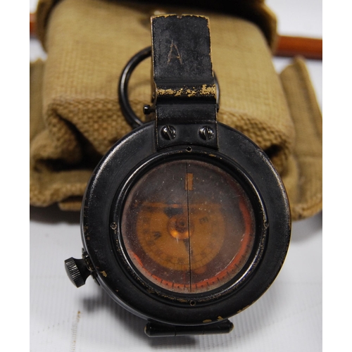 94 - Militaria interest: WWII period liquid pocket field compass contained in a black metal case, with cl... 