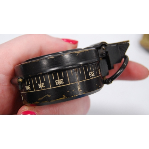 94 - Militaria interest: WWII period liquid pocket field compass contained in a black metal case, with cl... 