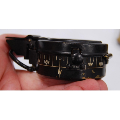 94 - Militaria interest: WWII period liquid pocket field compass contained in a black metal case, with cl... 