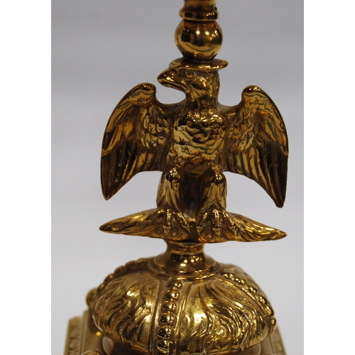 184 - Pair of Neo-Classical influence brass candlesticks, each with a shaped sconce above an eagle knopped... 