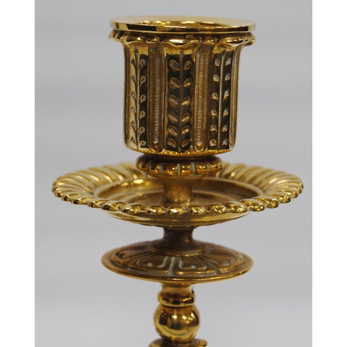 184 - Pair of Neo-Classical influence brass candlesticks, each with a shaped sconce above an eagle knopped... 