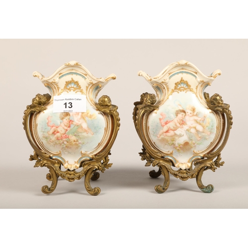 13 - Pair of gilt mounted garniture vases, with putti, 16 cm high (2)