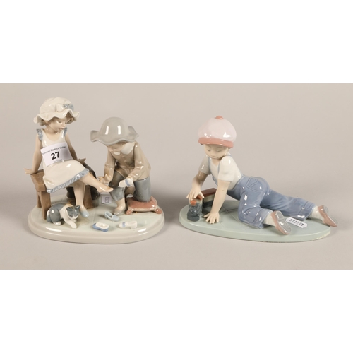 27 - Two Lladro figures; Boy with train, Girl trying slipper  (2)