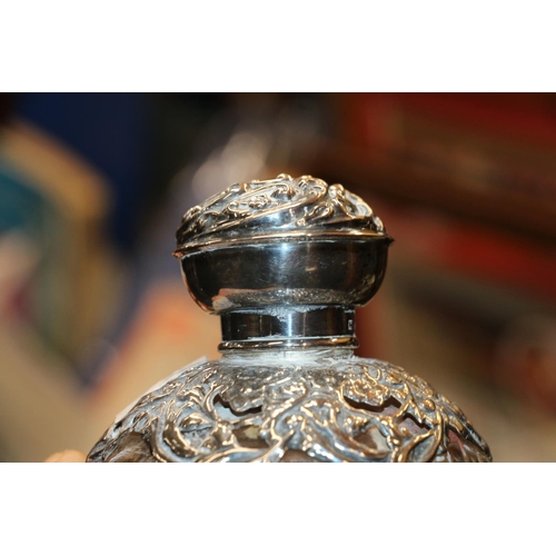 687 - Two silver mounted glass globular scent bottles, 11cm high.